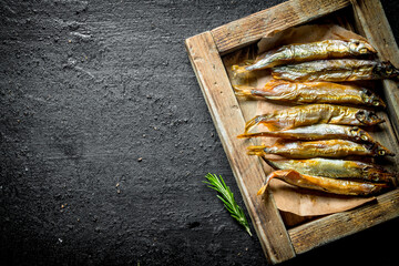 Smoked fish on the tray with the rosemary.