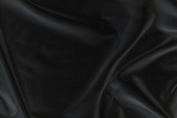 Fototapeta premium Smooth elegant black silk fabric or satin luxury cloth texture for abstract background