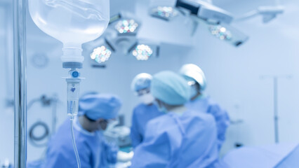 Blue tone picture of syringe pump with blurred background.Intravenous fluid used in the operating room while doctor perform surgery. Medical concept.