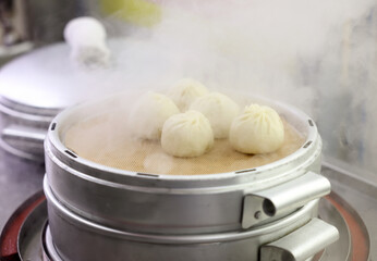 t's one of the Korean street food and snack culture, 'Mandu.' It's a scene of steaming dumplings in a street shop. The letter in the picture means dumplings in Korean