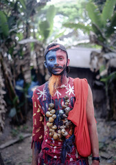 South asian young hindu religious boy wearing a wreath of dry snails and take makeup of a mad man...