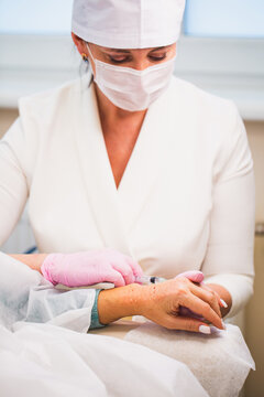 A woman doctor cosmetologist is receiving patients in a clinic of aesthetic medicine - skin correction and plastic surgery