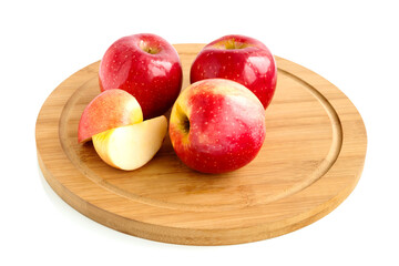 Delicious juicy red apples on a wooden kitchen board.Isolated on a white background.