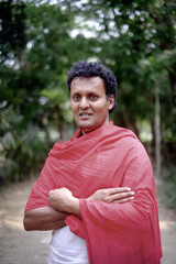 Portrait of a hindu religious middle aged monk wearing traditional gerua dress