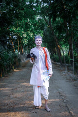 South asian hindu religious young aged boy cosplays as a foreteller in gajan festival 