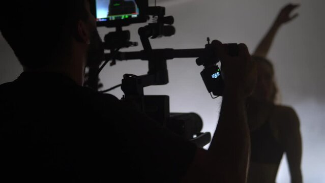 Red camera on the gimbal with flowline during the recording of modern dance performance