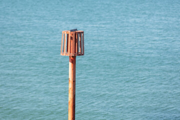 A red marker in the sea off Margate Beach marking where an outfall pipe runs out into the water