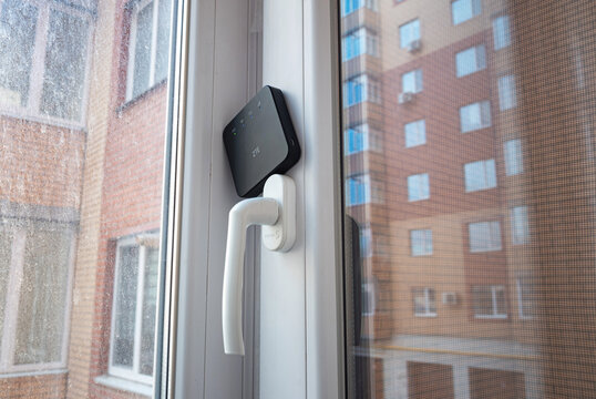 Kyiv, Ukraine- 18 January 2023: Small 3g 4g mobile wireless ZTE internet router on window at home. To connect to the internet during a blackout, the absence of wired internet.