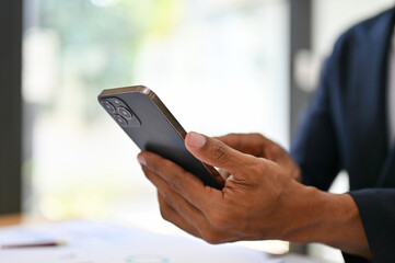 close-up image, Businessman using his smartphone at his desk. chat, message, text