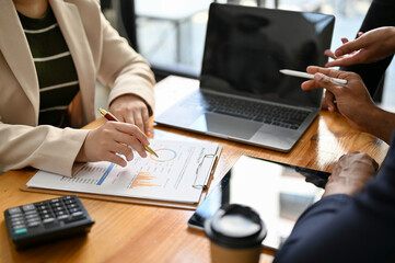 Team of professional Asian financial analysts or accountants working together. cropped image