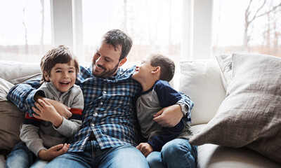 Hug, happy and portrait of father with children on the sofa for love, care and relax in family home. Smile, funny and dad with boy kids for quality time, affection and comedy on the couch of a house - obrazy, fototapety, plakaty