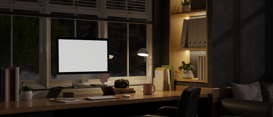 Modern and contemporary home working room at night with computer mockup. dark home office - obrazy, fototapety, plakaty