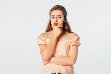 Hmm interesting. Curious brunette girl planning perfect plan, rub chin, squinting suspicious and thoughtful peek at camera, thinking, pondering between nice choice
