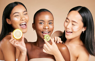 Happy woman, friends and fruit for healthy skincare, nutrition or vitamin C and facial moisturizer against studio background. Portrait of female models with smile holding organic food for health diet