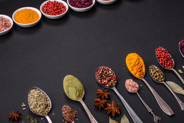 Composition consisting of variations of spices in white bowls and metal spoons
