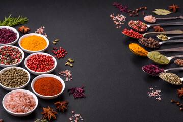 Composition consisting of variations of spices in white bowls and metal spoons