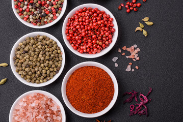 Composition consisting of variations of spices in white bowls and metal spoons