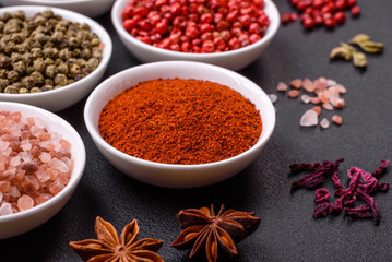 Composition consisting of variations of spices in white bowls and metal spoons