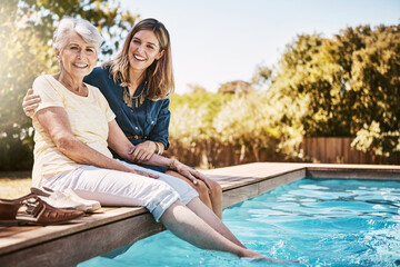 Fototapeta na wymiar Women in portrait, relax together and swimming pool, love and care with quality time during summer vacation. Elderly mother, daughter and vacation, outdoor pool and wellness lifestyle with family