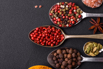 Composition consisting of variations of spices in white bowls and metal spoons