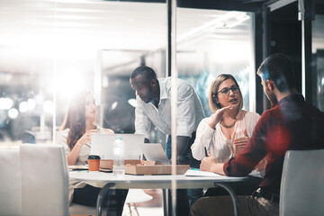 Teamwork, late night help and team at workshop with ideas, laptop and food planning startup project. Conversation, overtime and advice for business people brainstorming at creative marketing agency.