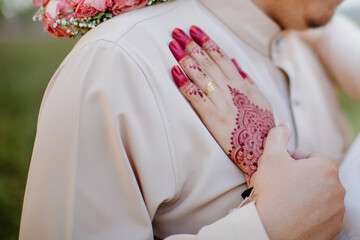 Woman Hands with red henna tattoo. Hands of Malay bride girl with red henna tattoos.