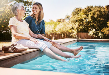 Women relax together by swimming pool, love and care, quality time during summer vacation. Elderly...