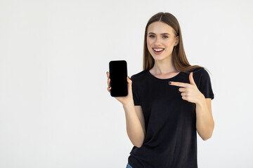 Portrait of a businesswoman showing blank screen mobile phone isolated over white background