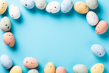 Easter quail eggs als border frame over blue background. Spring holidays concept with copy space. Top view