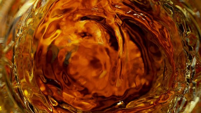 Super Slow Motion Detail Shot of Rum Swirling in Glass at 1000fps.