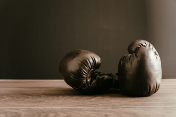 Boxing gloves on wooden table