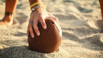 Playing american football on the beach
