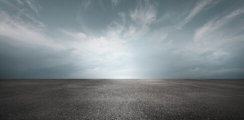 Sky Background Horizon with Dramatic Clouds and Empty Dark Asphalt Street Floor - 562990386