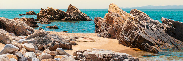 Panoramic view of picturesque beach, bizarre rocks on sandy shore of Aegean Sea. Deserted beach...
