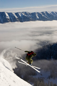 Young woman catches air at Fernie Alpine Resort, BC, Canada