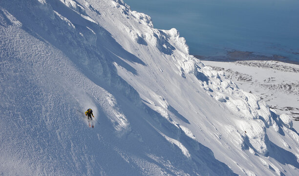 Skiers descend from the summit of Mt. Augustine