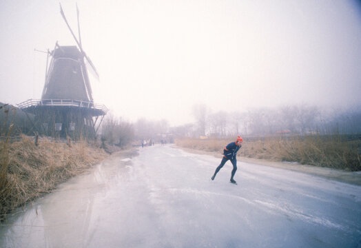 A young man skates on the road in the morning, Holland, Europe.
