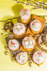 Traditional Easter cake. Festive sweet food with icing and decor. Eggs, nest, willow