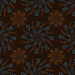 Seamless pattern of orange and blue hearts flowers on a brown background. Print with hearts in kaleidoscopic ornamental style.