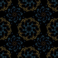 Seamless pattern of yellow and dark blue hearts flowers on a black background. Print with hearts in kaleidoscopic ornamental style.