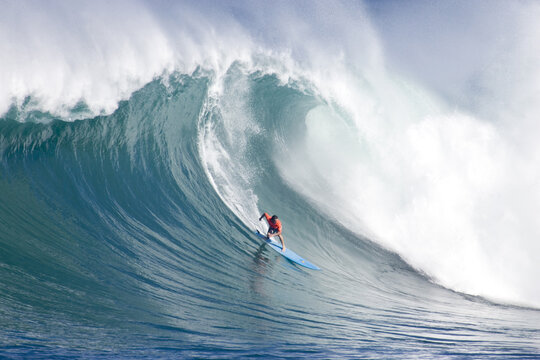 Man big wave surfing near Oahu.