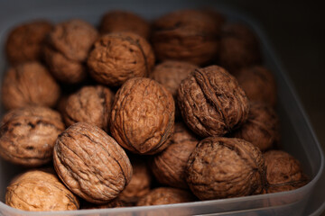 Walnuts in a plastic bowl. 