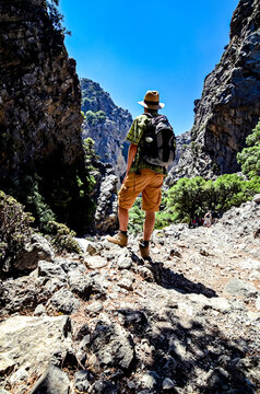 Group of tourists hiking in the canyons and mountains in Crete