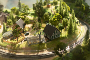 Toy Town. Model of village in mountains. Terrain model. Surroundings for railway.