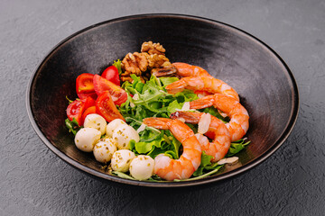 Salad with fresh arugula leaves, mozzarella cheese and shrimps