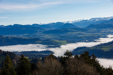 Landscape of Austrian mountains, blue sky and fog