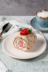 Strawberry Roll Cake. Cream and strawberry log cake with coffee on stone background. close up