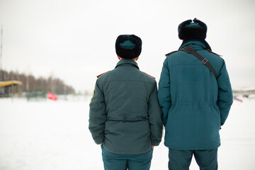 Two rescue workers. Men in uniform. Warm lifeguard uniform in Russia.