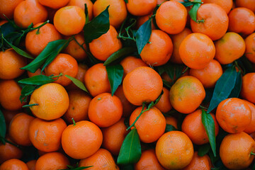 Background. The texture of orange tangerines scattered in a box