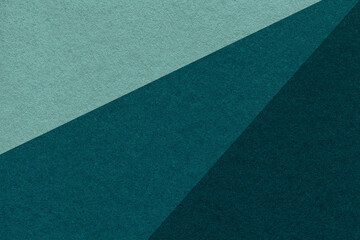 Texture of old craft cyan, emerald and teal color paper background, macro. Vintage abstract green...